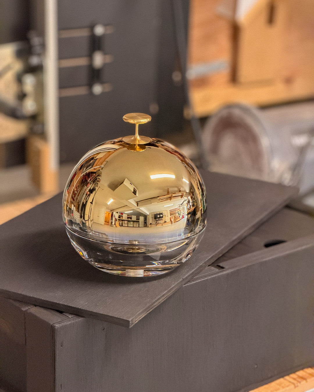 Jackpot, a 24k gold domed crystal ashtray, resting on its flame-blackened crate in the Murmmr studio